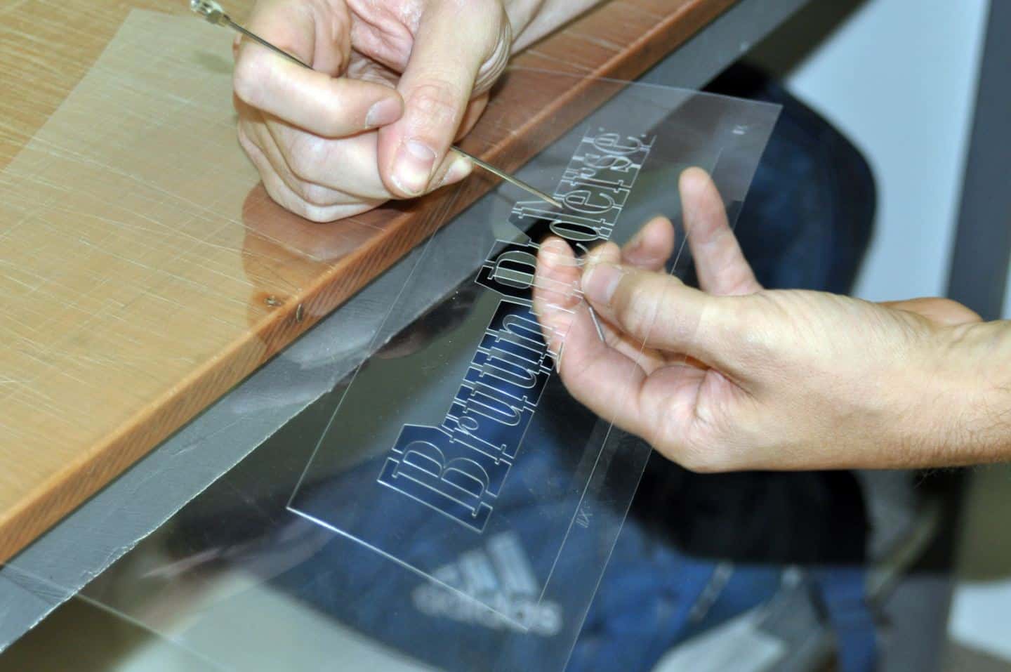 Production of enamel signs for homes and businesses at Ramsign. Cutting out the stencil.