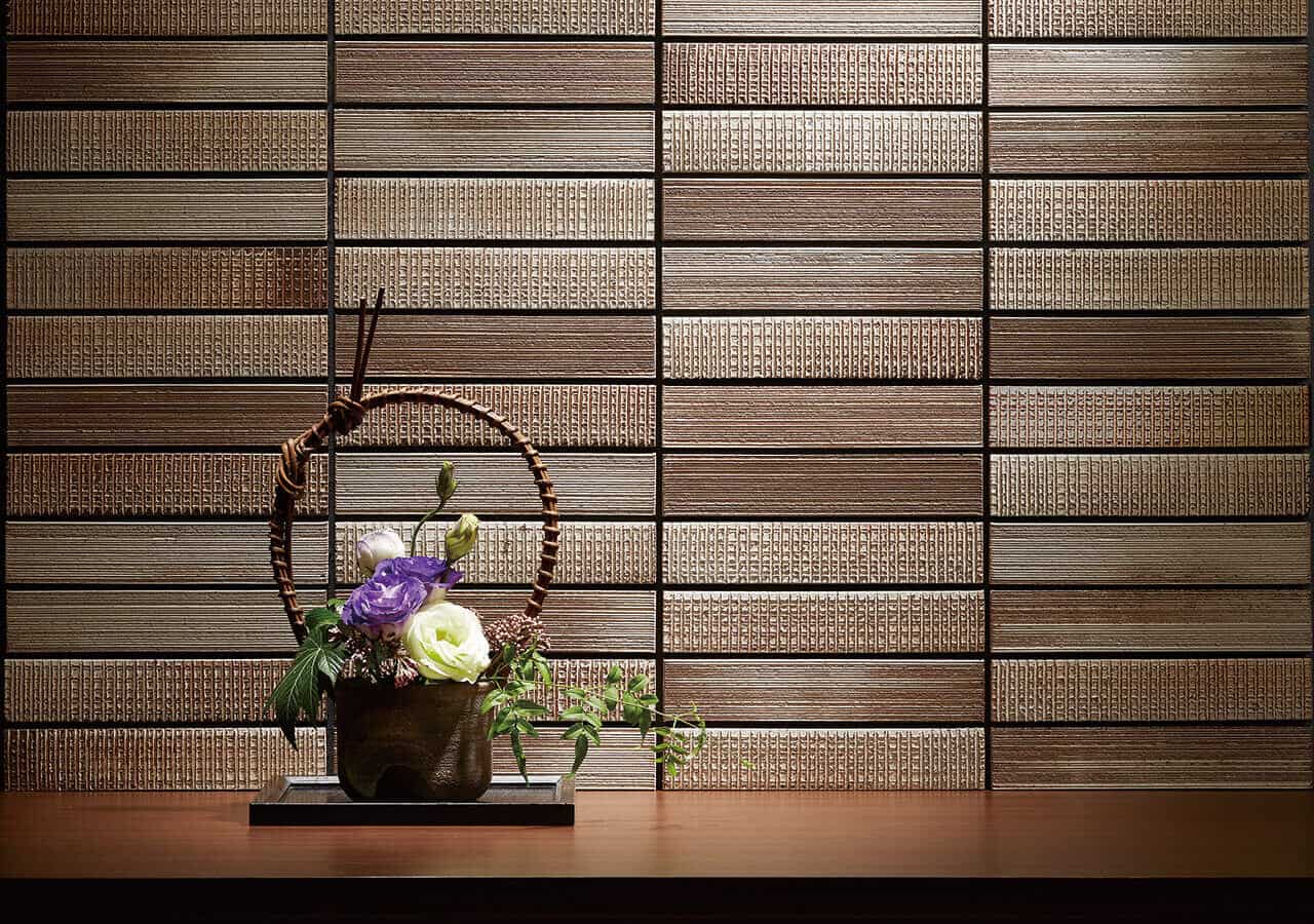 Homura textured wall tiles from Raven with a basket of flowers in front