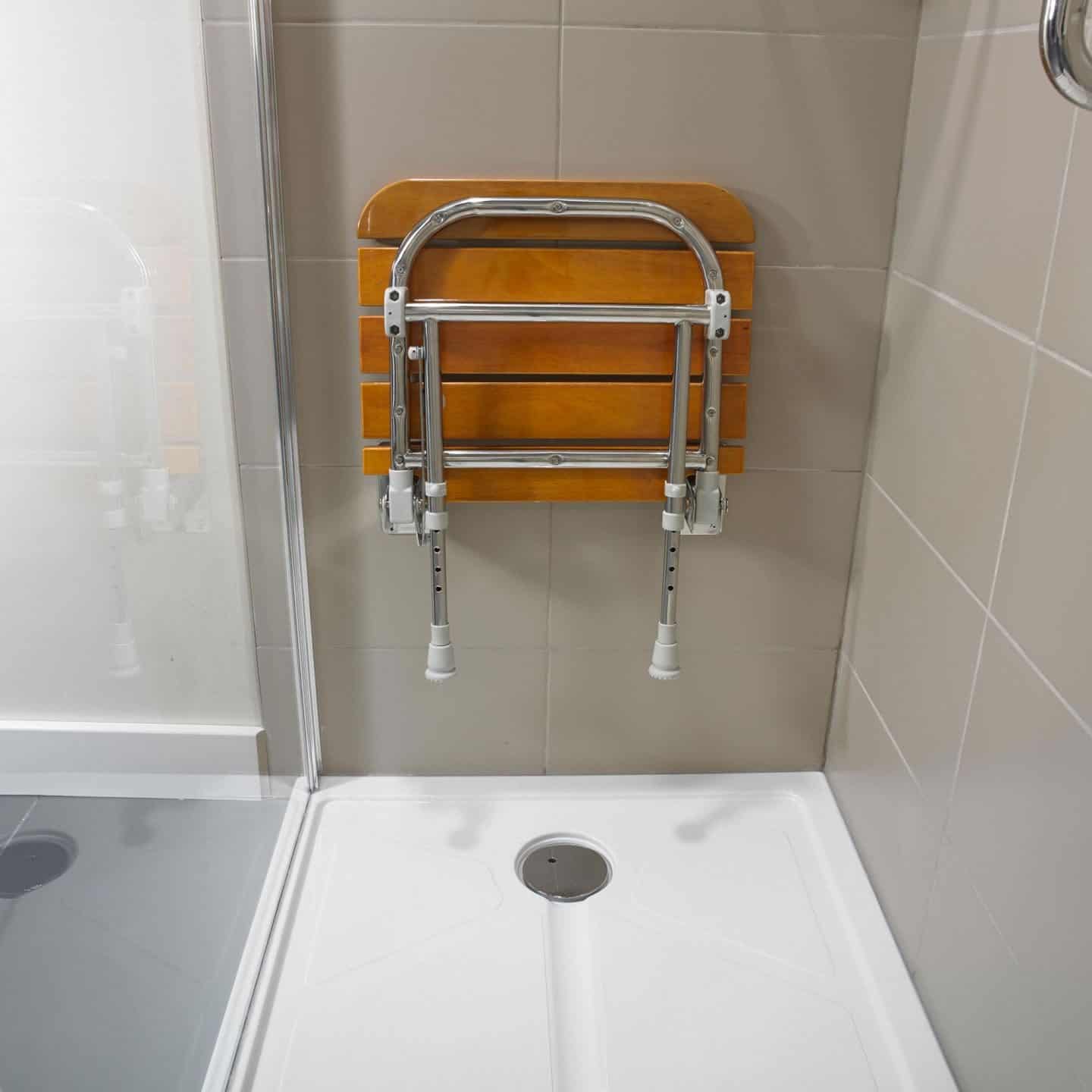 Accessible bathroom design from Premier Care Bathrooms. A shower seat is useful for people with balance or mobility issues.