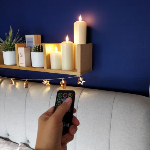 Remote Control Faux pillar LED candles from Candled on a bedroom shelf 5