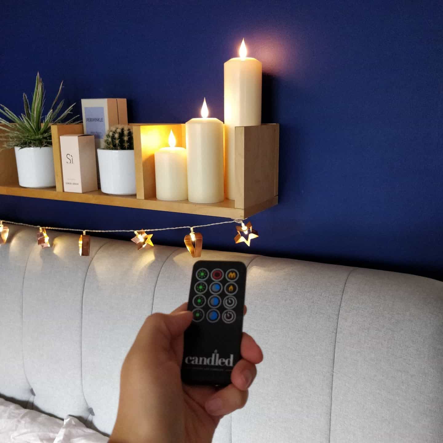 Remote Control realistic LED candles from Candled on a bedroom shelf 6