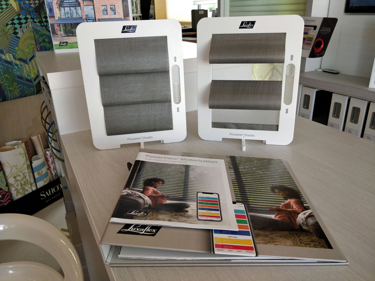 Display samples of Luxaflex blinds and instructions booklet on a worksurface