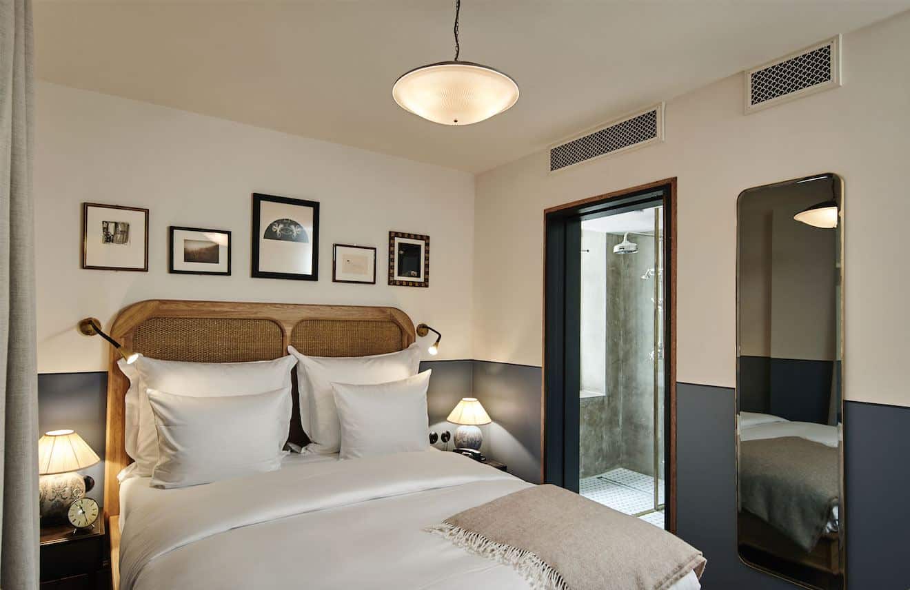 Sander Hotel, a design hotel in copenhagen. The beds have rattan headboards and crisp white linen.