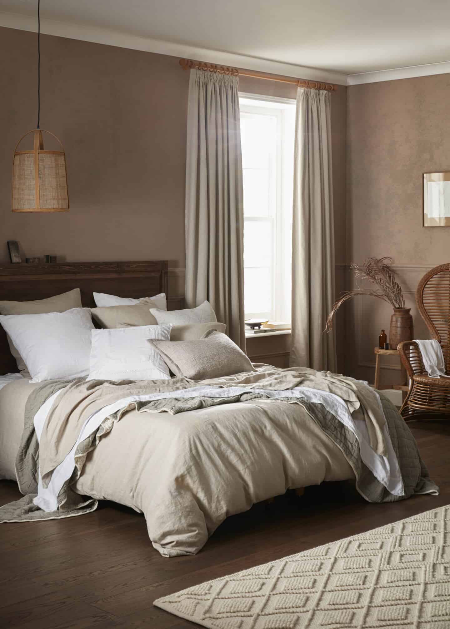 Bedroom featuring earthy neutral colours, wooden furniture and lots of natural materials and textures