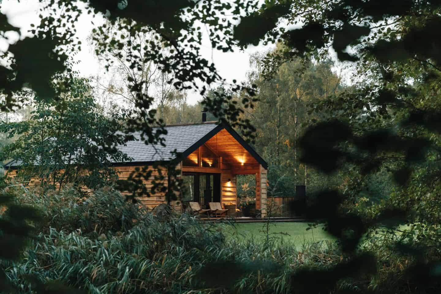 A wooden house as seen through the tree branches