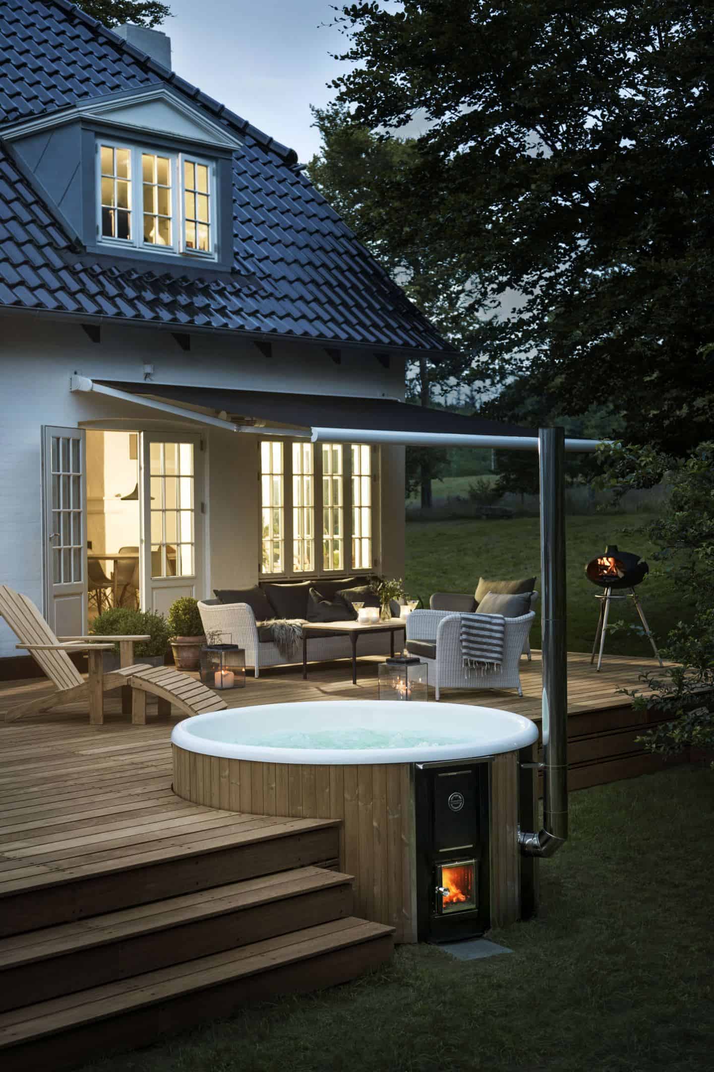 A luxurious wood-fired hot tub brings that holiday feeling to your summer staycation in your garden