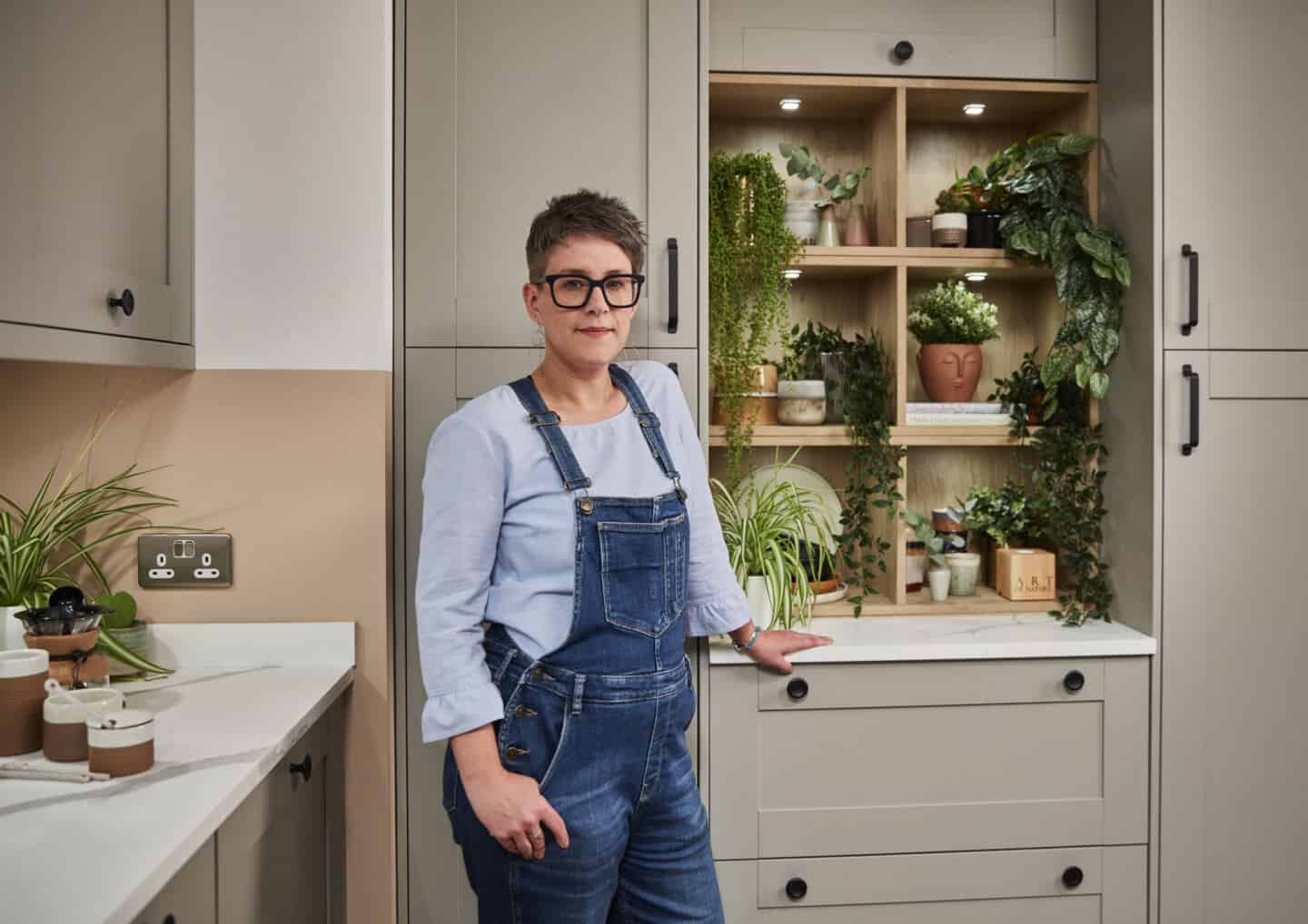 Award-winning Interior Design Blogger Stacey Sheppard stood in the Tatton Pebble Kitchen from Magnet Kitchens.