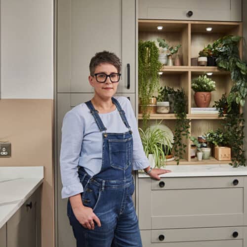 Stacey Sheppard stood in a grey Magnet kitchen