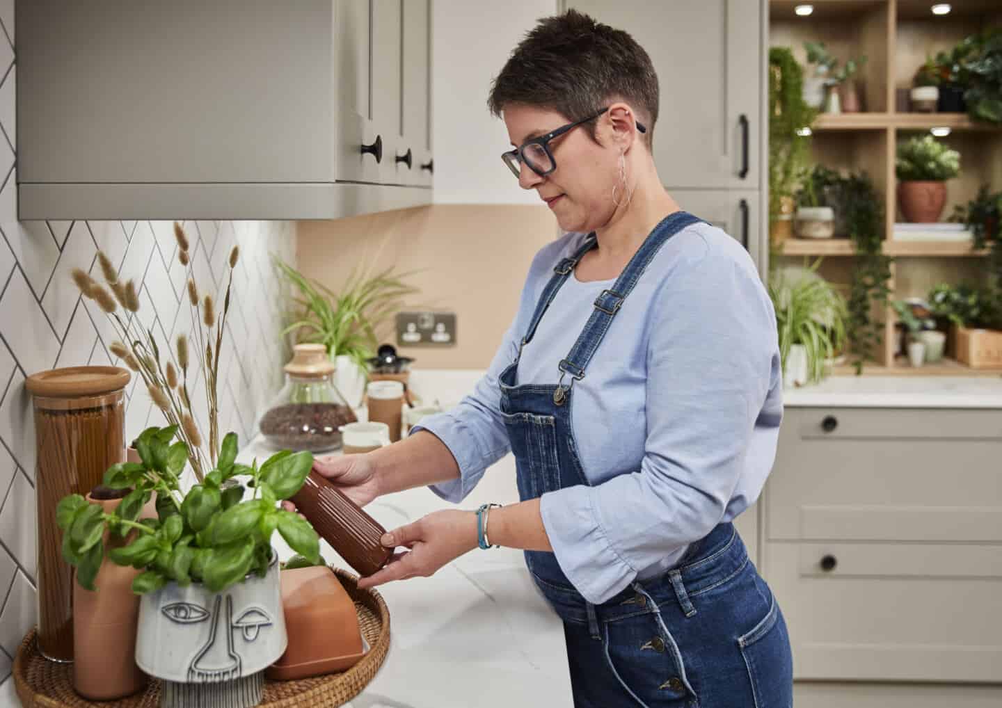 Biophilic kitchen designs provide a multi-sensory experience through natural materials and textures. Here Sblogger Stacey Sheppard arranges kitchen accessories on a marble effect worktop.