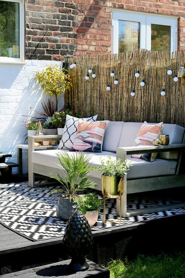 Swoonworthy Garden Makeover featuring reed screening, outdoor sofa and outdoor rug