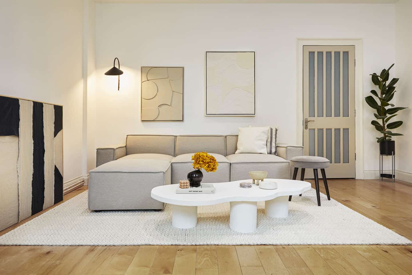 A neutral living room featuring a bouclé sofa collection designed by Interior designer Luke Arthur Wells in collaboration with Swyft Home