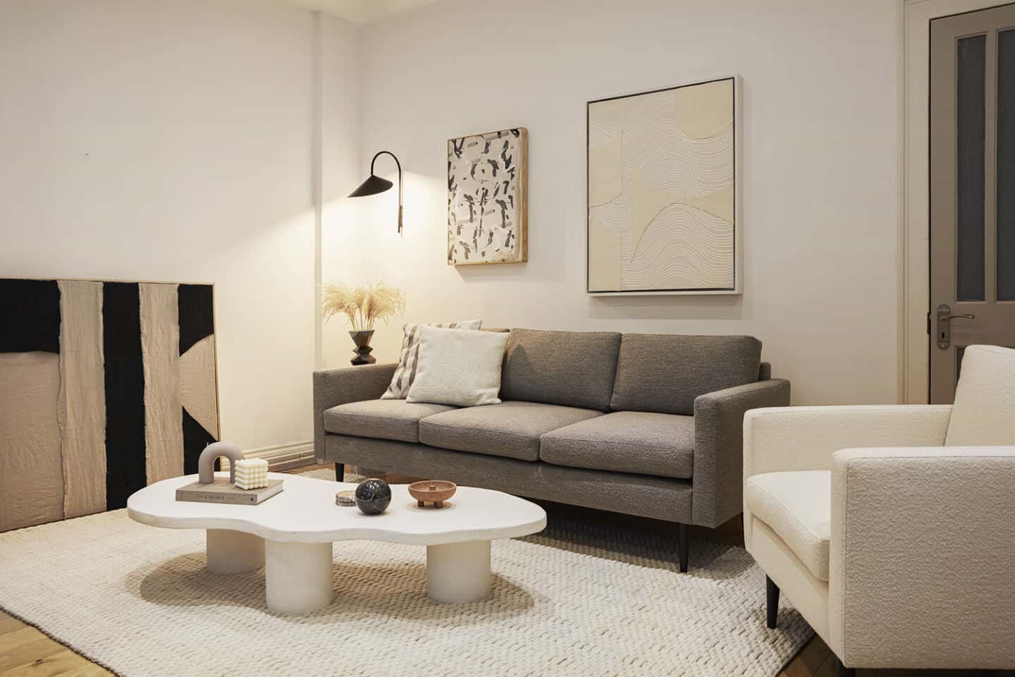 A neutral living room featuring a bouclé sofa collection designed by Interior designer Luke Arthur Wells in collaboration with Swyft Home