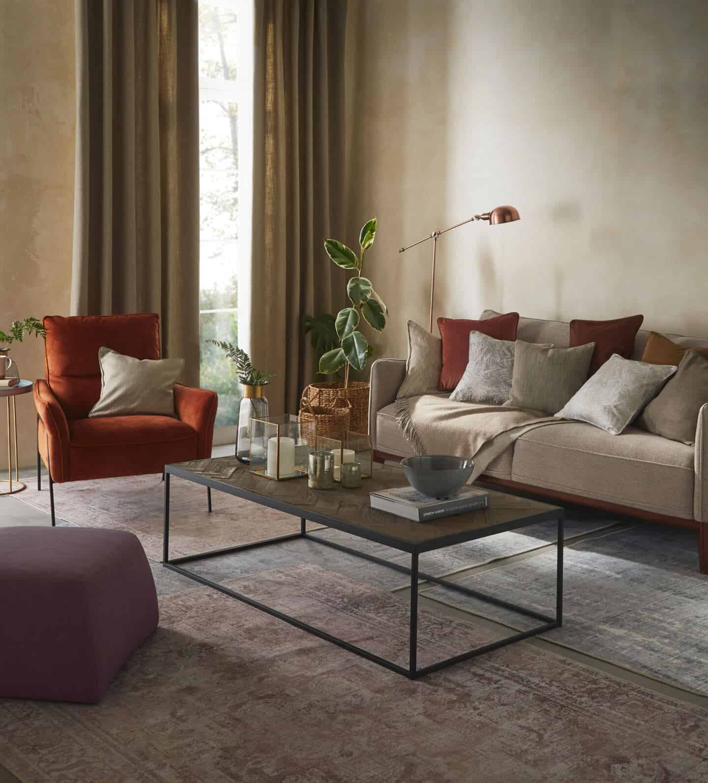 a living room featuring sofa, armchair and coffee table with lots of textured accessories