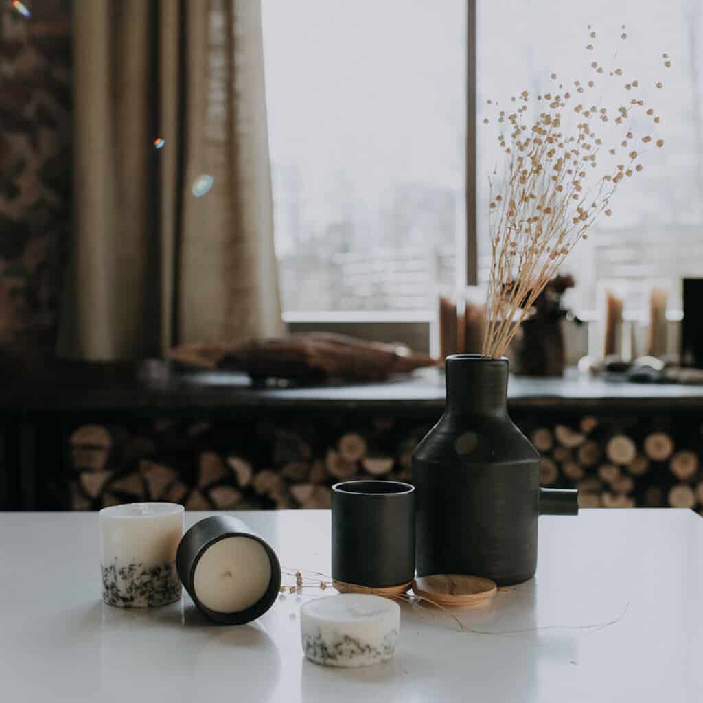 Textured Lives. Using texture in interiors to bring your home to life.  Candles on a white surface next to a vase containing dried flowers