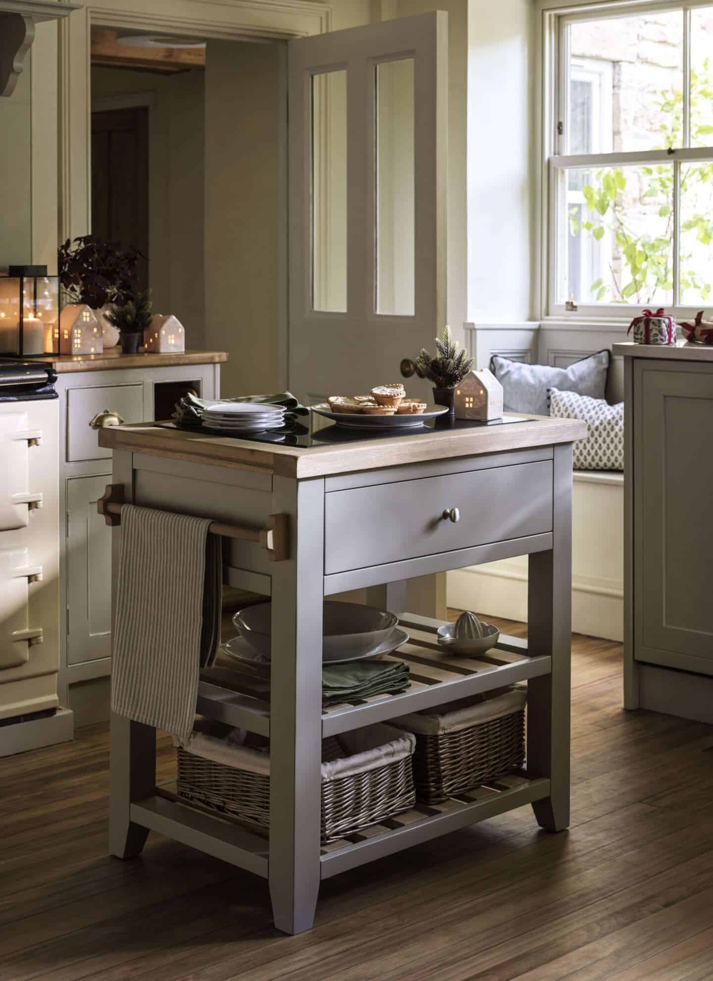 A small wooden kitchen island in the middle of a traditional kitchen helps to create a more functional kitchen