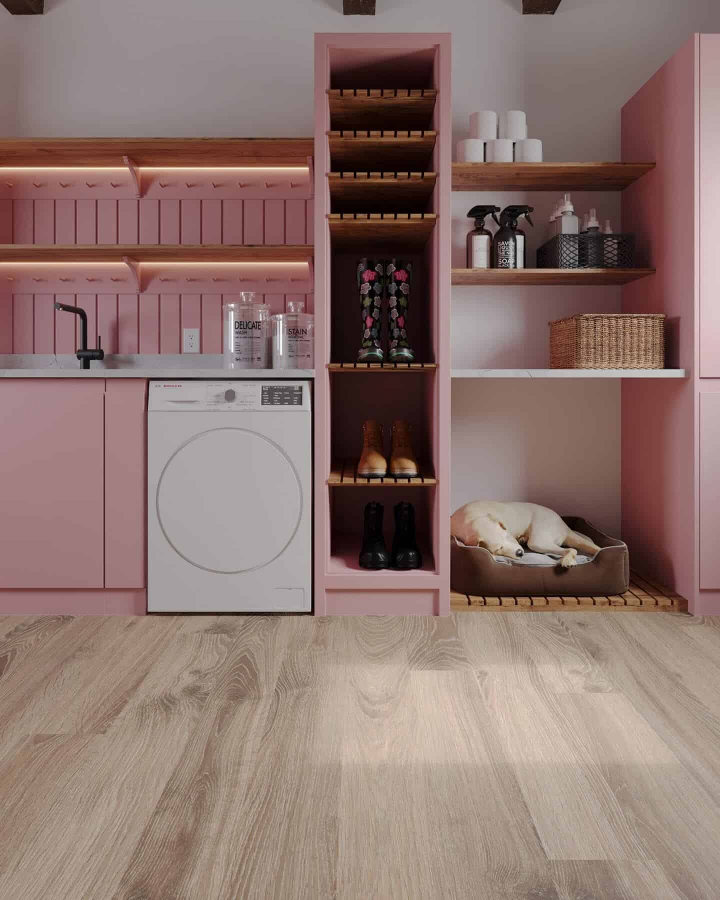 A pink kitchen featuring wide oak plank flooring creates a luxurious home