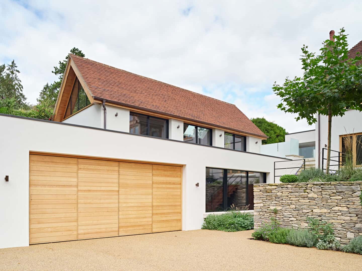 A modern home with bi-fold wooden garage doors