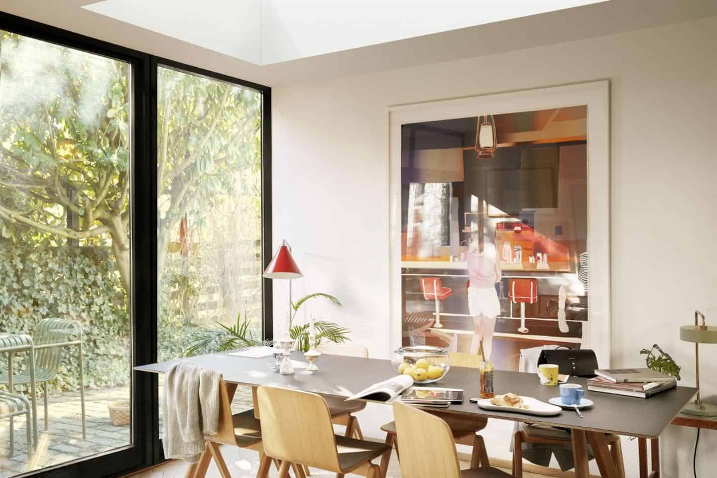 Vario by VELUX Bespoke Flat Roof Windows pictured above a dining table with large artwork hung on the wall behind