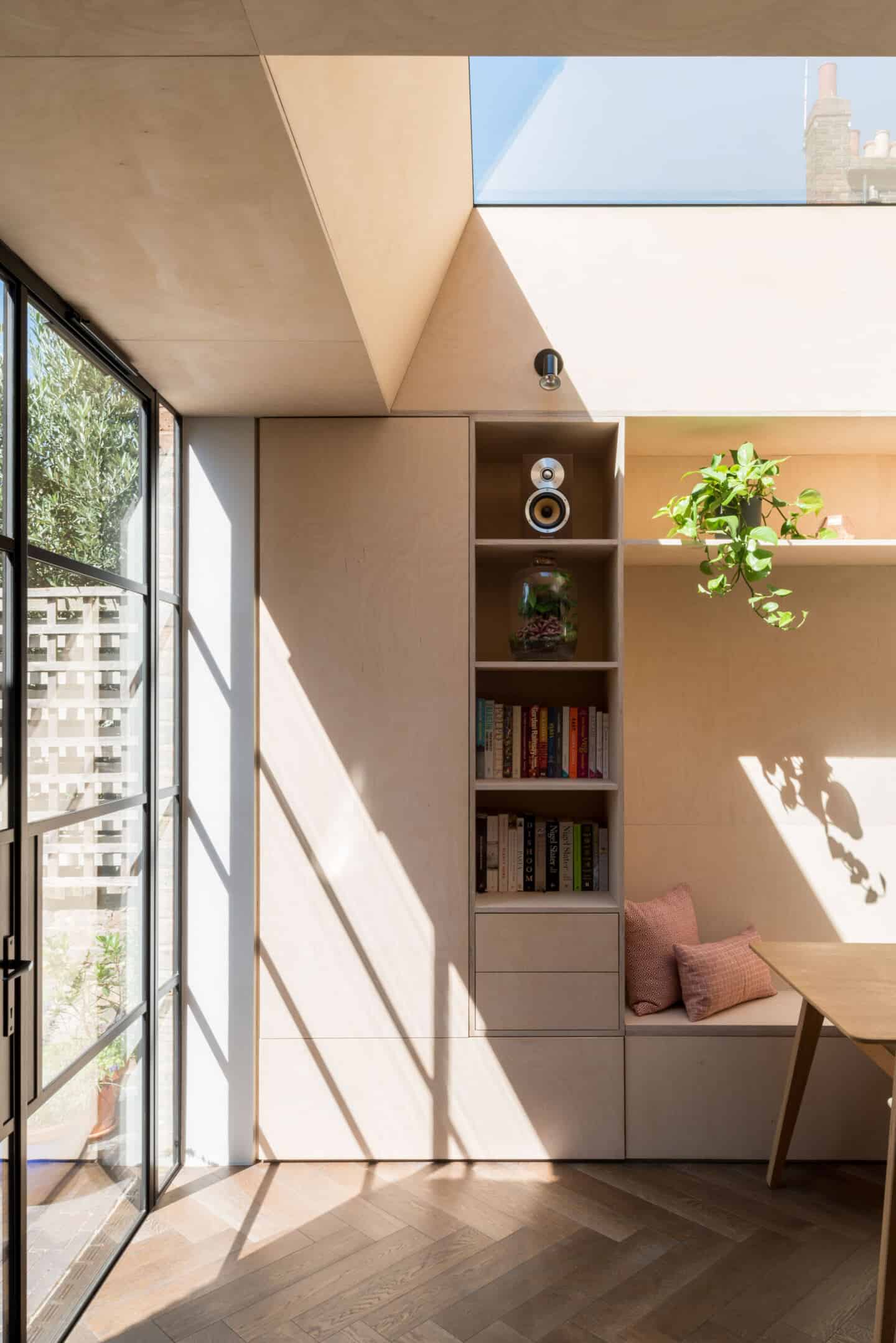 Natural light flows into this dining area from glass doors and a roof light