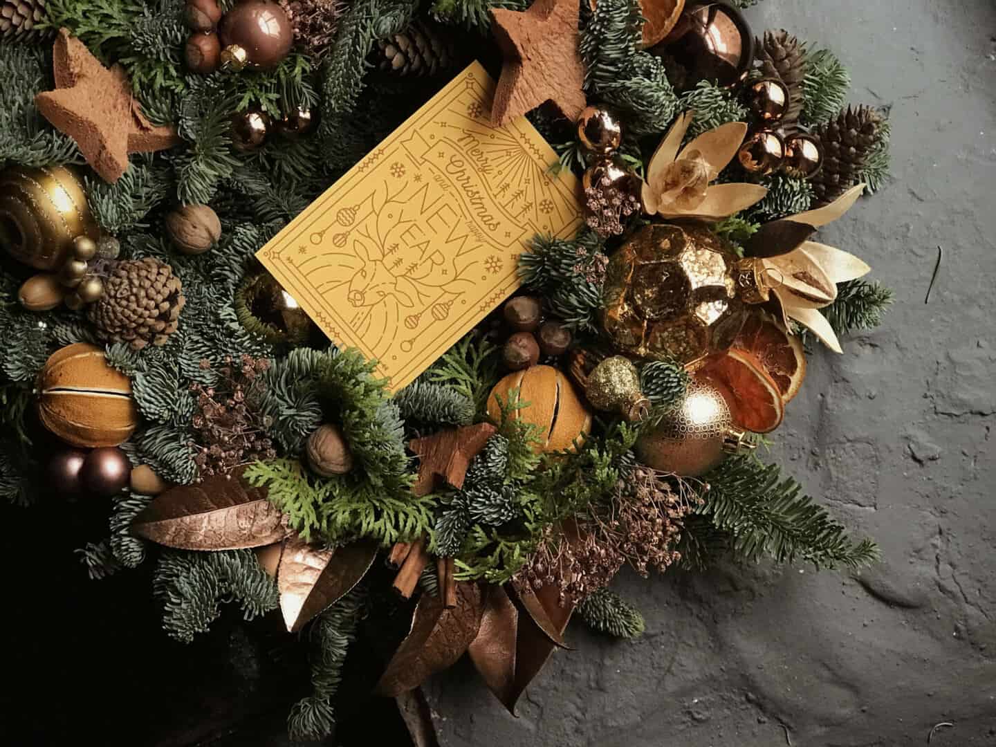 A Christmas wreath decorated with metallic ornaments