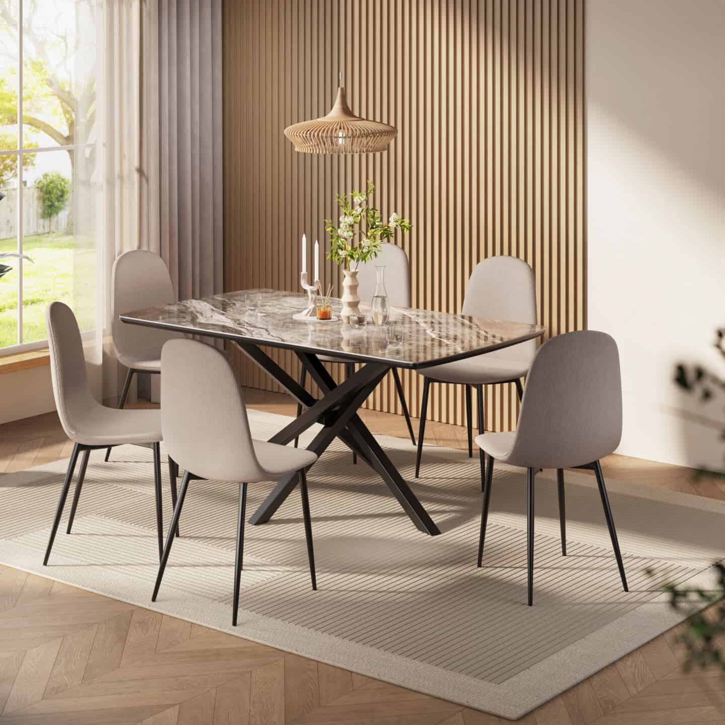 A light an airy dining room with large windows. A wooden slat wall on the wall behind the marble dining table and upholstered grey chairs