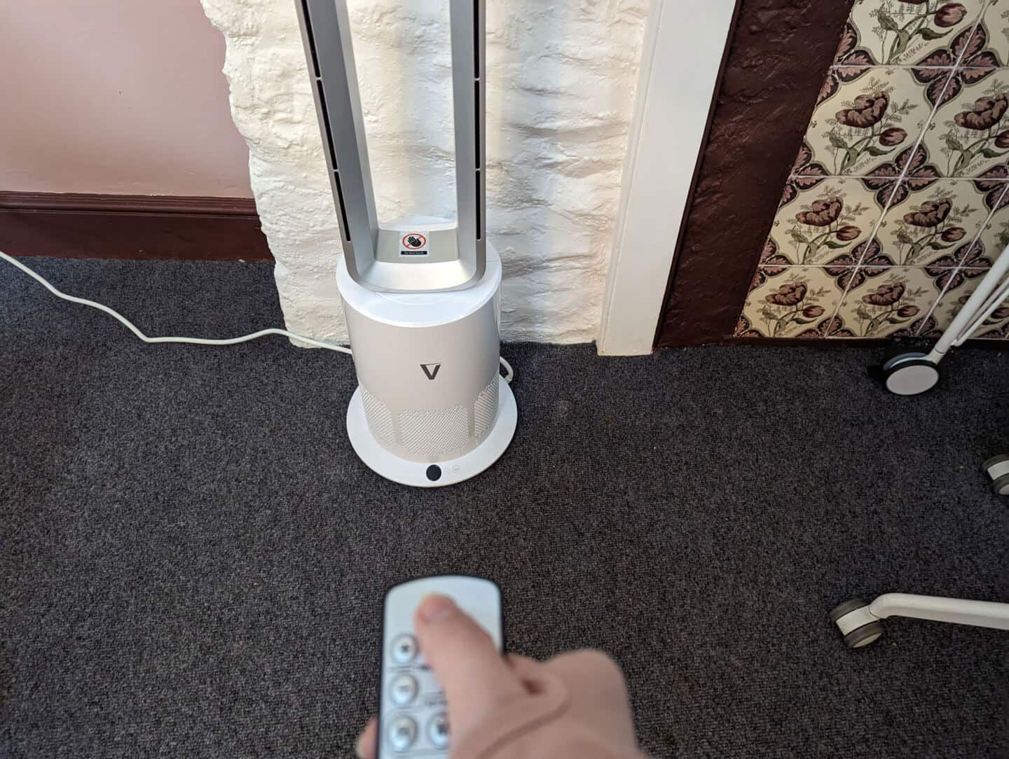 Vortex Air Bladeless Fan Heater being operated by remote control