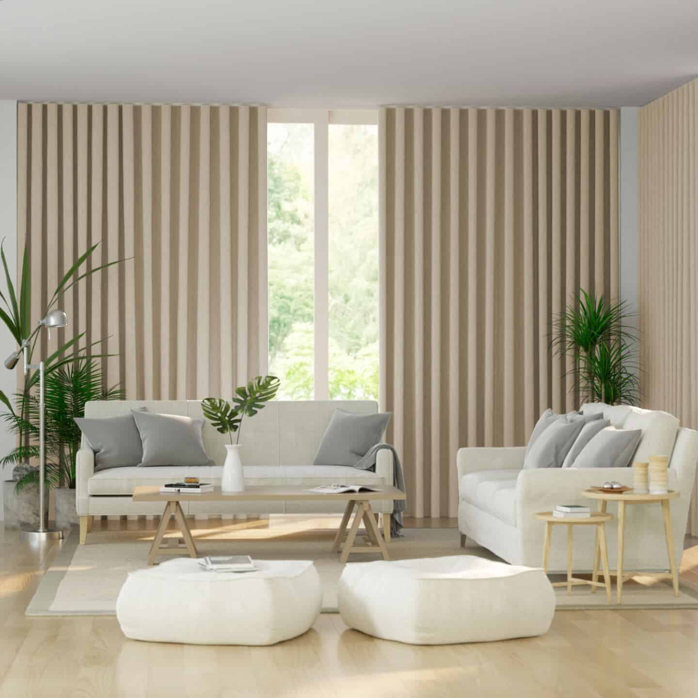 A neutral living room featuring two white sofas and two white pouffes on a wooden floor with floor-to-ceiling curtains covering large windows.