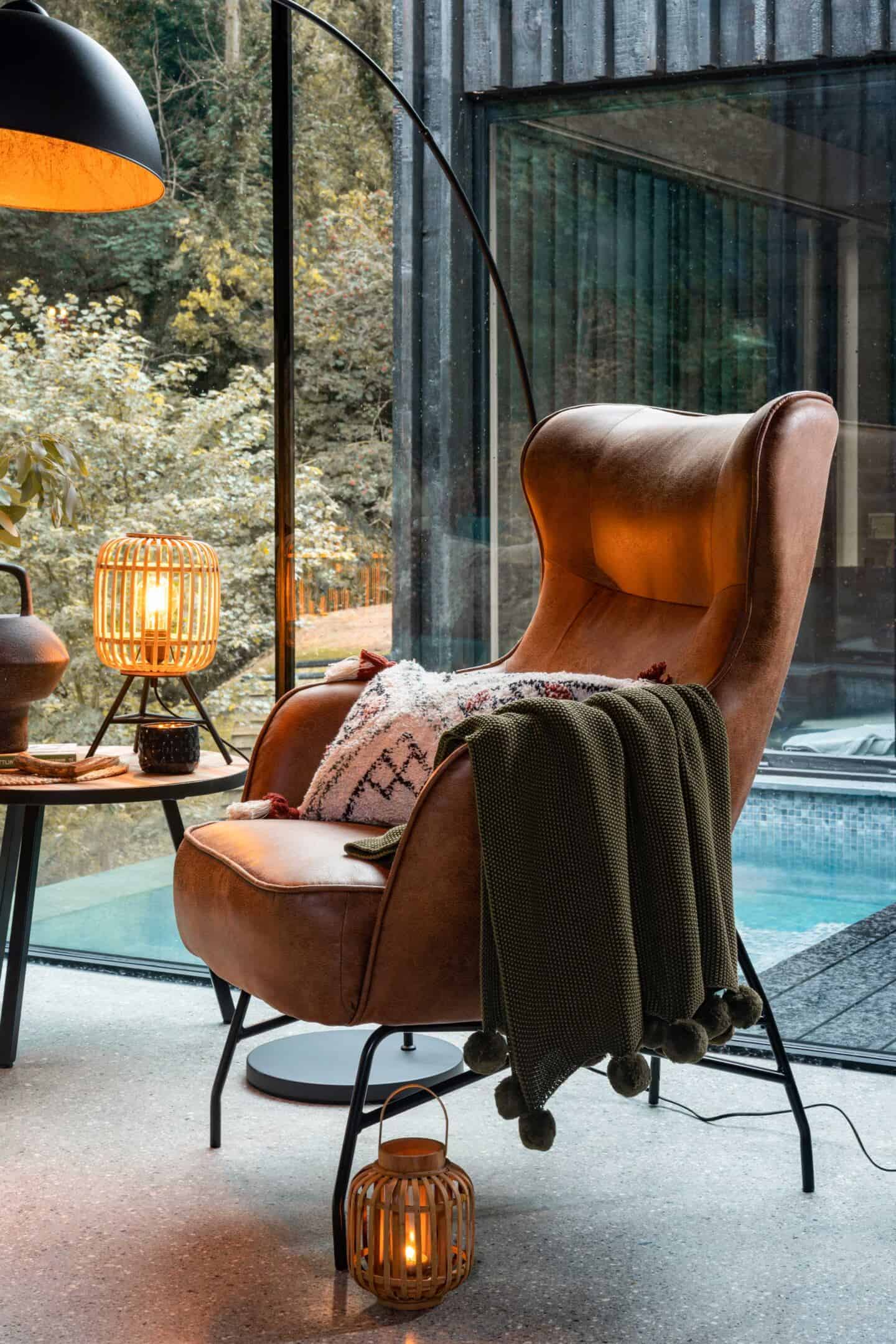 A cosy leather armchair, wooden side table and soft textured textiles provided by Wayfair furnish the Wildwood Spa in North Devon