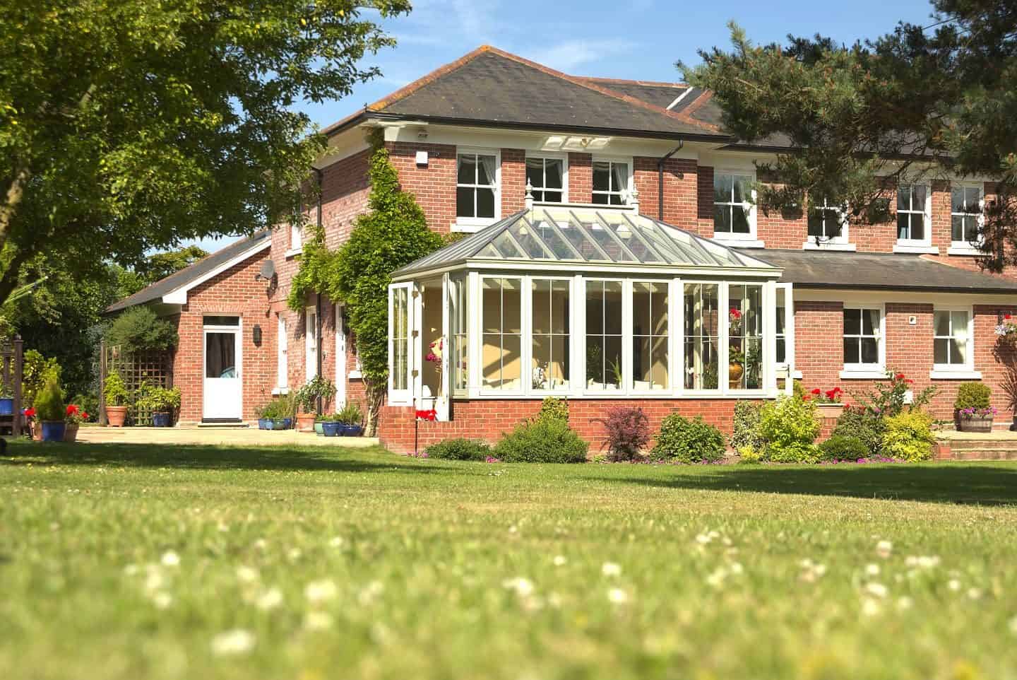 A conservatory attached to a red brick home