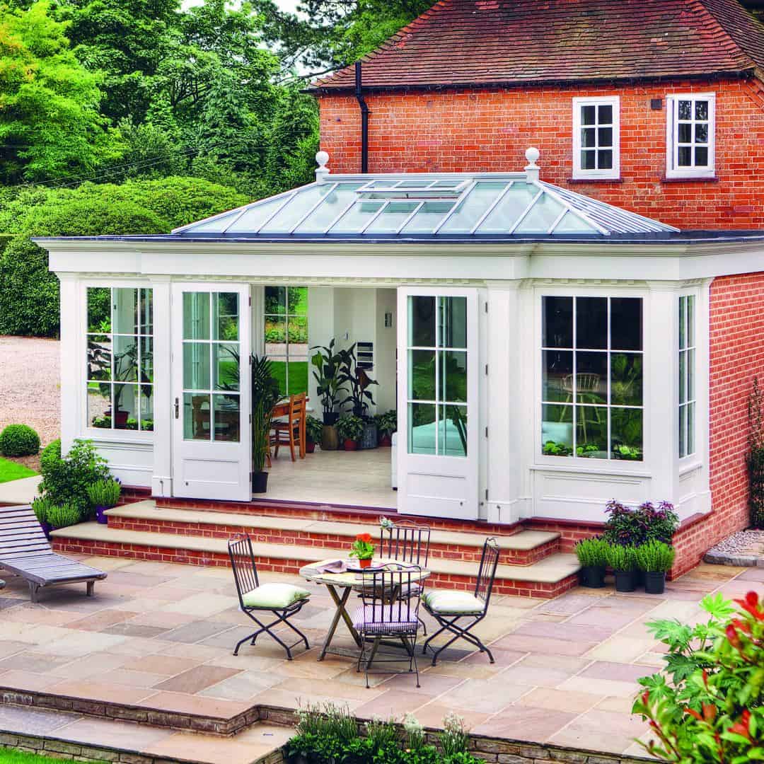 A red brick house with a glazed extension