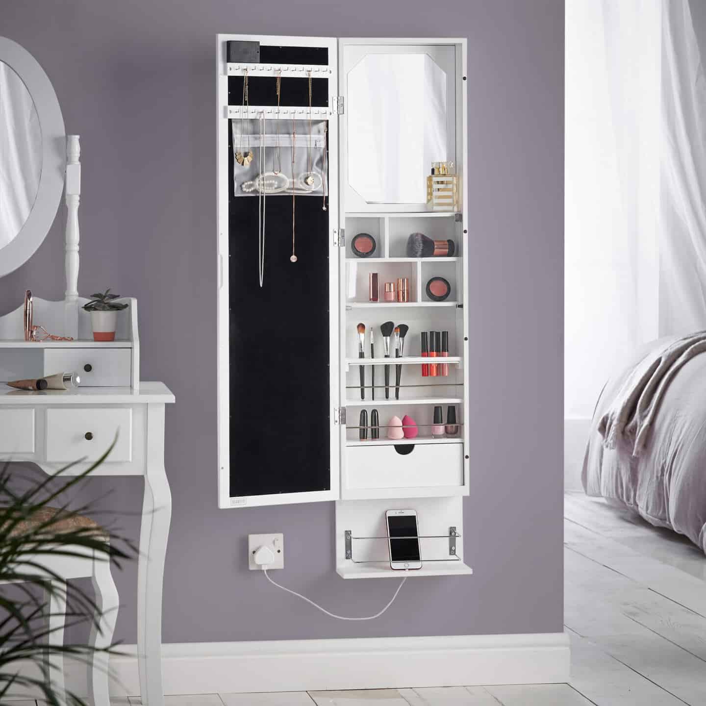 A wall hung mirror with storage space inside for make-up and jewellery