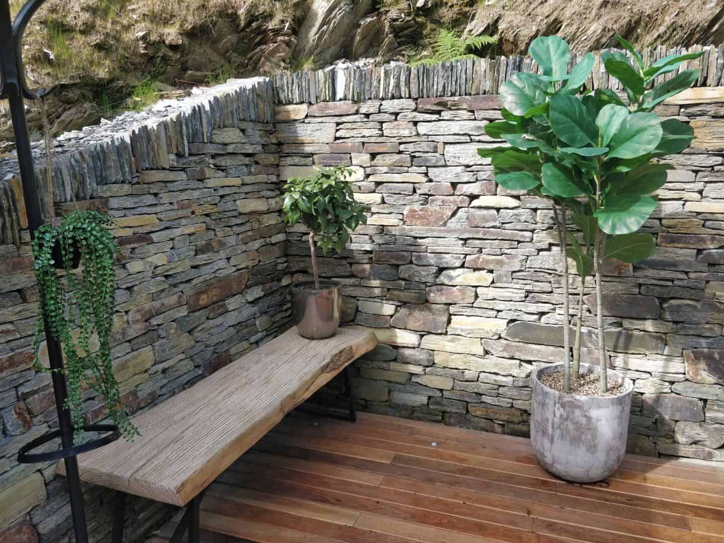 The stone wall that surrounds the upper deck at WIldwood Spa is made using materials that can be found in the surrounding landscape