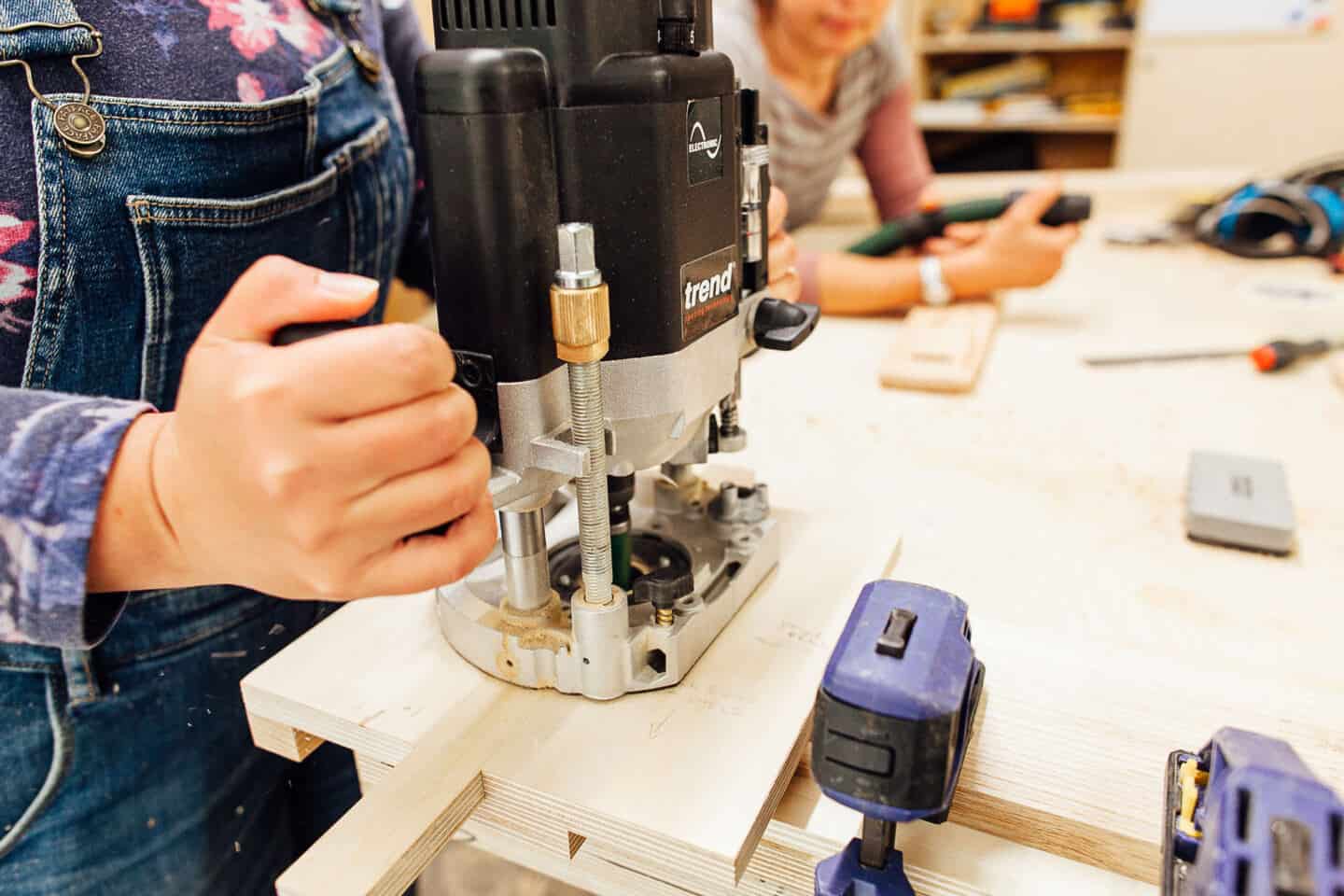 A woman uses a router