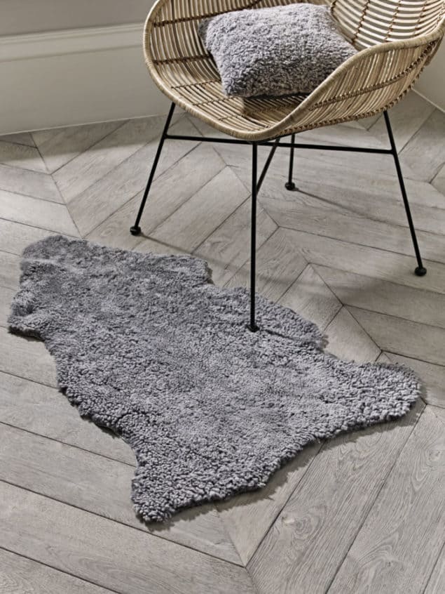 Create a cosy winter home with this grey curly sheepskin rug from Cox & Cox