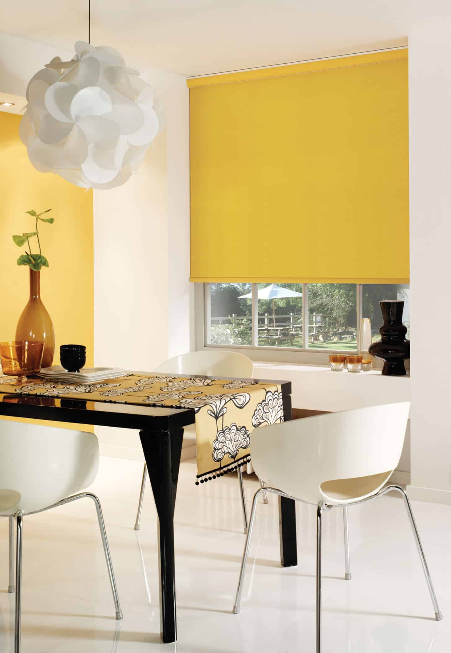 Pantone Colour of the Year 2021 - Illuminating. The colour psychology behind using yellow in interiors. Yellow blinds from English Blinds on a window behind a dining table